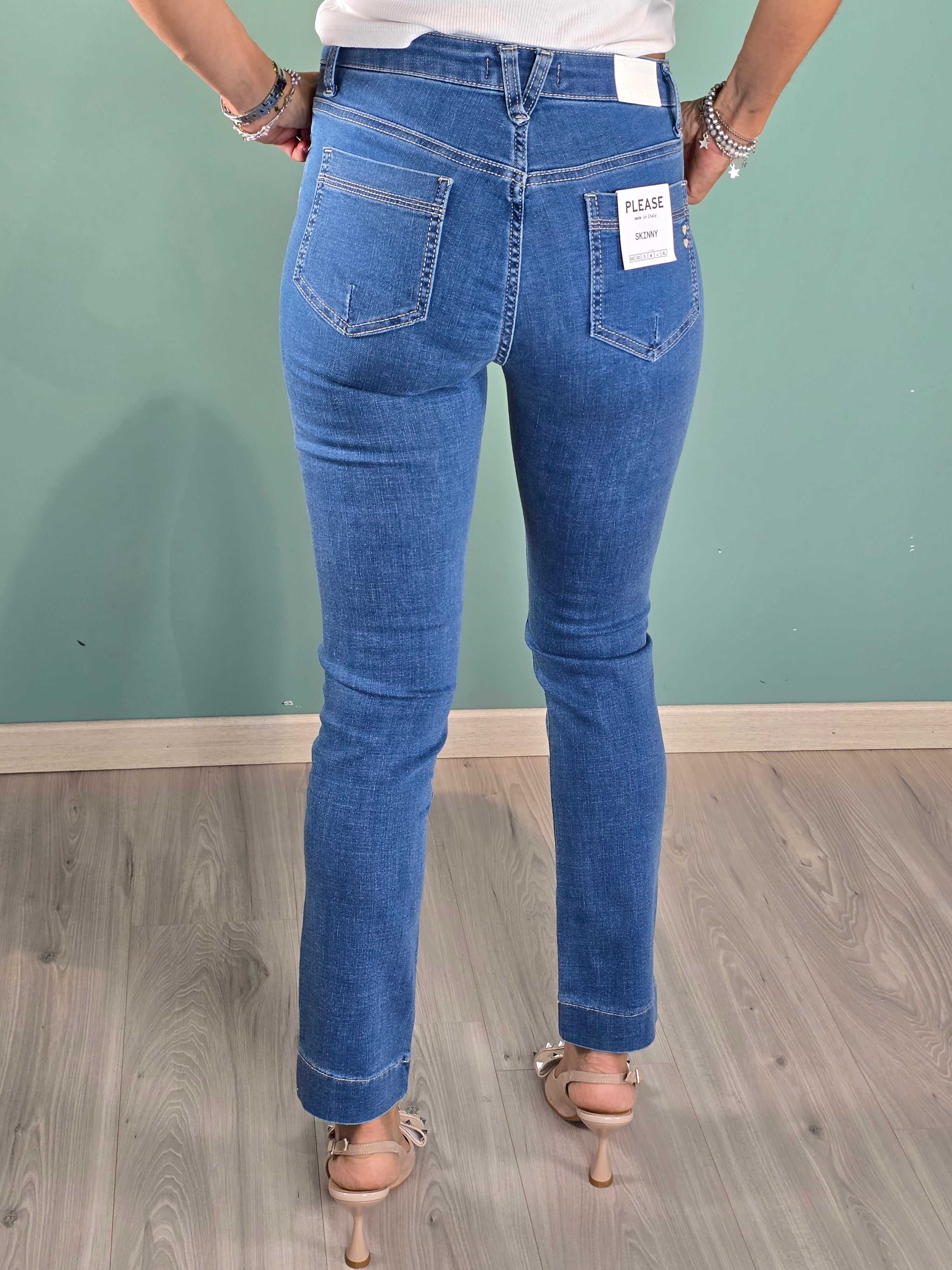 Back view of Denim Skinny Please jeans in regular fit on a model against a teal wall background