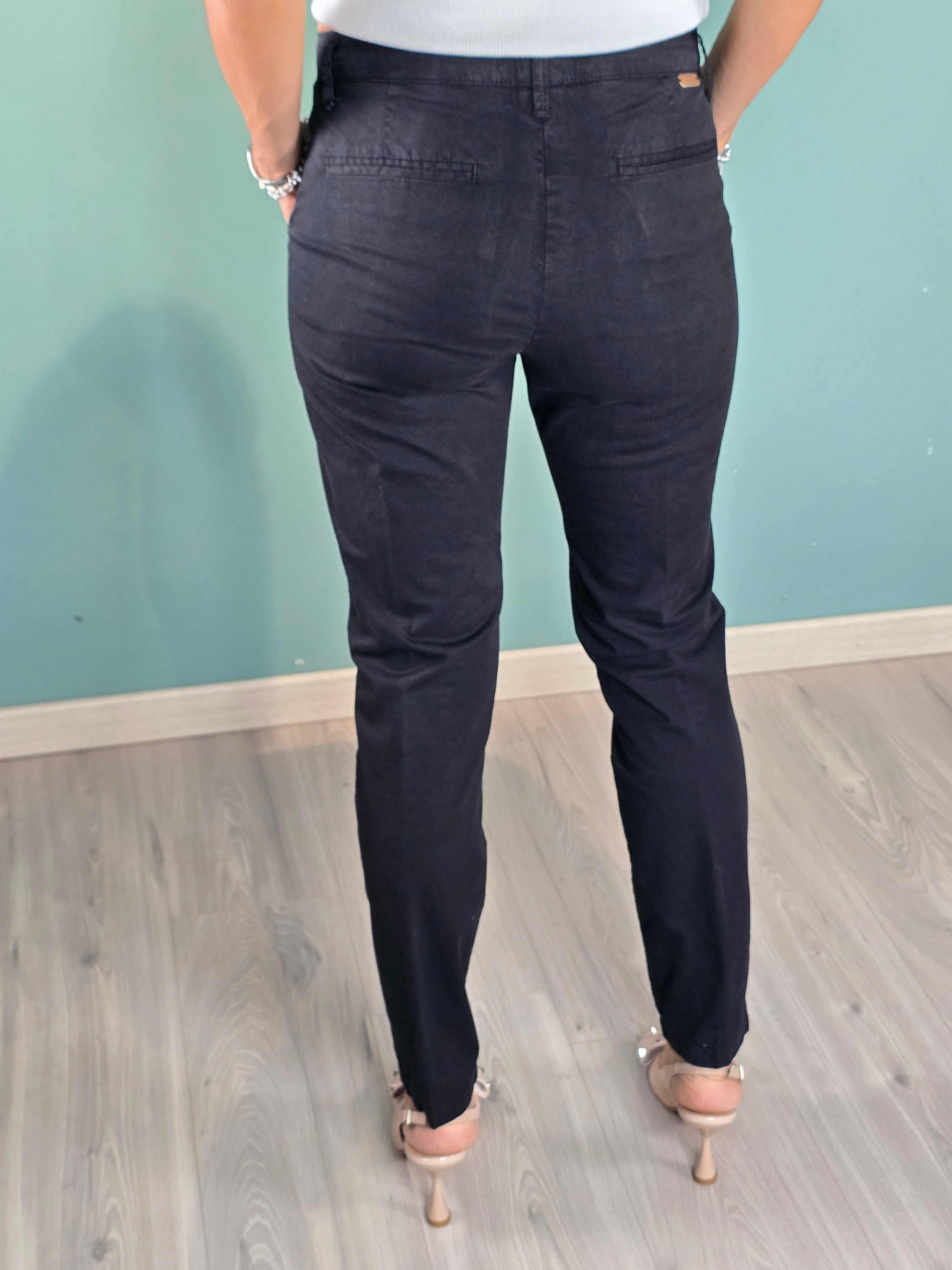 Back view of a model wearing dark Pantalone Cuba Squad cigarette-fit pants made of cotton and elastane